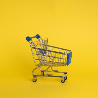 Empty shopping cart on yellow background