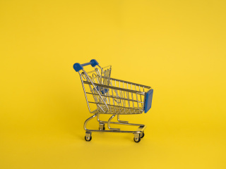 Empty shopping cart on yellow background